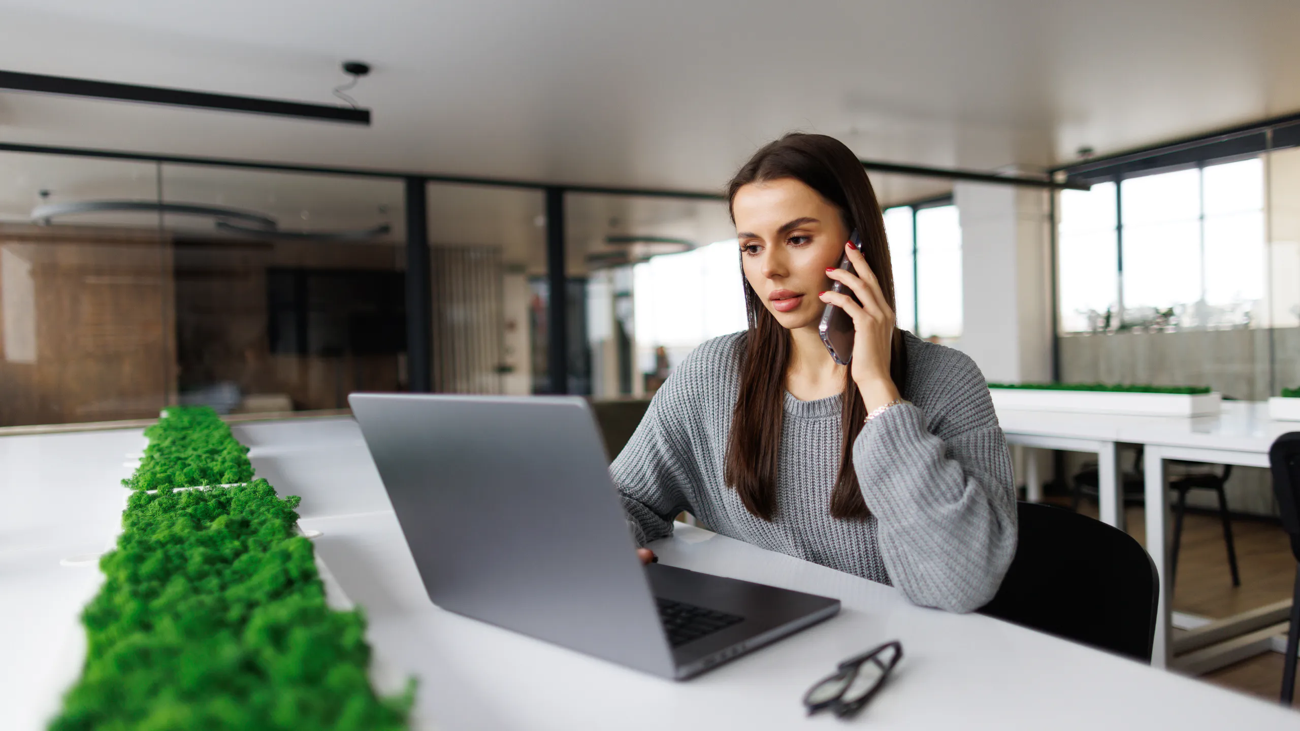 Customer support representative handling a client inquiry in a contemporary workspace.